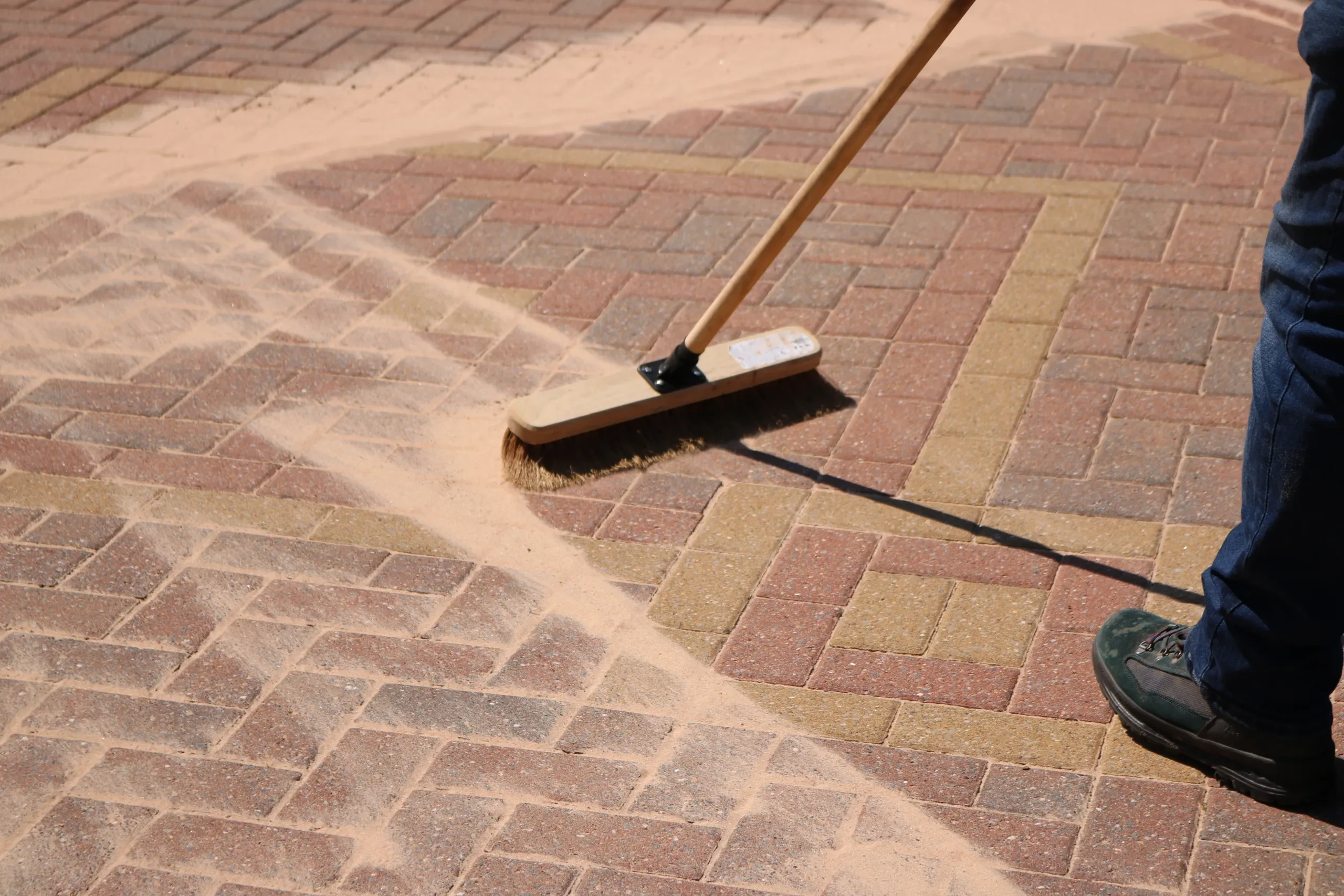 Paver sanding with polymeric sand on driveway